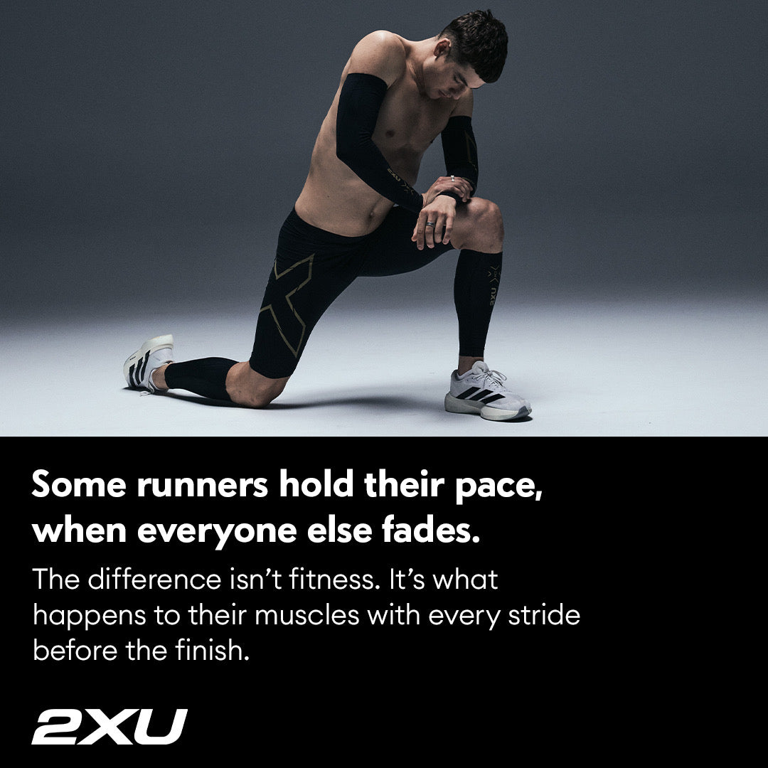 A runner kneeling in 2XU compression calf sleeves and tights, over the line: some runners hold their pace when everyone else fades