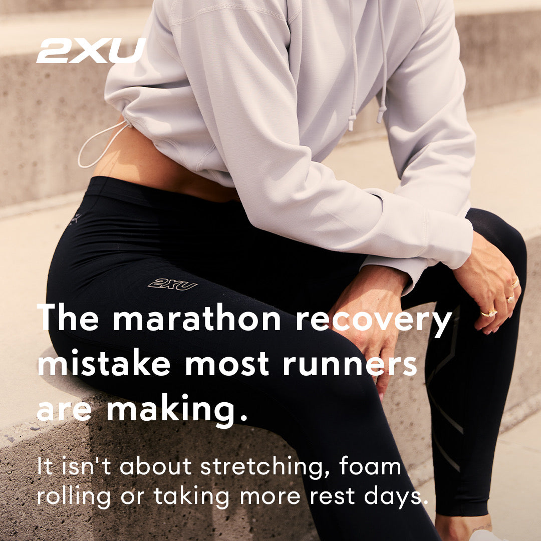 A runner resting on steps in 2XU compression tights, over the line: the marathon recovery mistake most runners are making